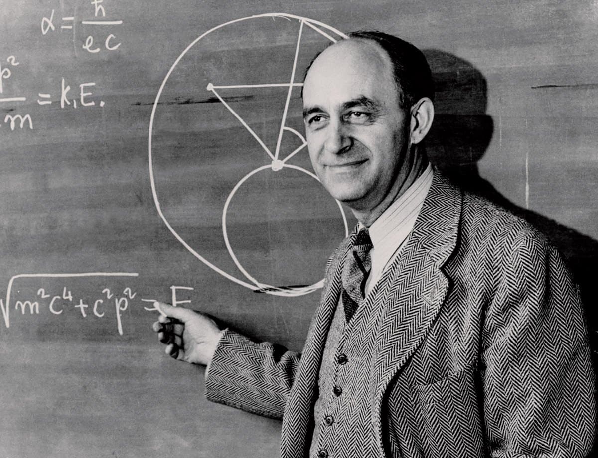 Enrico Fermi at a chalkboard, pointing to the relativistic energy-momentum equation